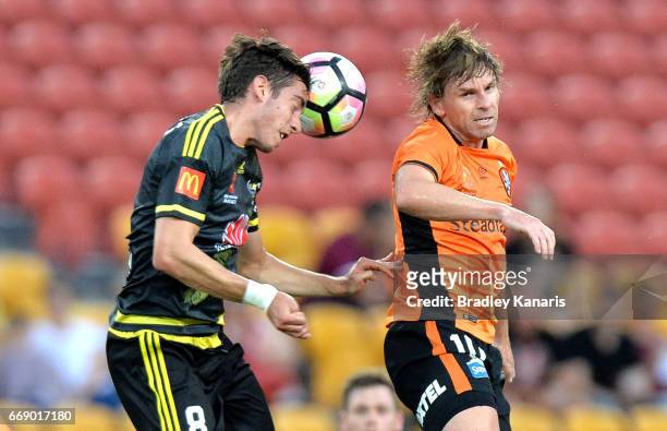 Alex Rodriguez of the Phoenix and Brett Holman of the Roar compete for the ball during the round 27 A-League match between the Brisbane Roar and the...