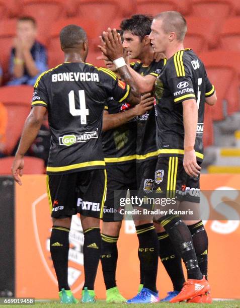 Guilherme Finkler of the Phoenix is congratulated by team mates after scoring a goal during the round 27 A-League match between the Brisbane Roar and...