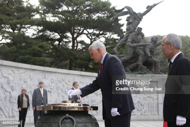 Vice President Mike burns incense at Seoul National Cemetery on April 16, 2017 in Seoul, South Korea. During the three day visit to South Korea, Vice...