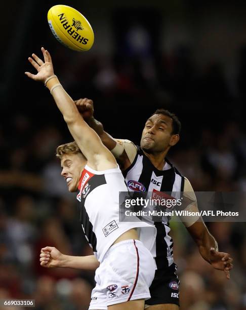 Jack Lonie of the Saints and Travis Varcoe of the Magpies compete for the ball during the 2017 AFL round 04 match between the Collingwood Magpies and...