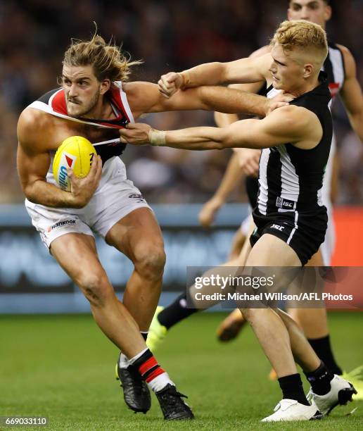 Josh Bruce of the Saints is tackled by Adam Treloar of the Magpies during the 2017 AFL round 04 match between the Collingwood Magpies and the St...