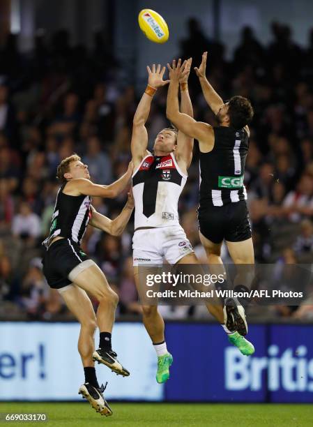 Will Hoskin-Elliott of the Magpies, Maverick Weller of the Saints and Alex Fasolo of the Magpies compete for the ball during the 2017 AFL round 04...
