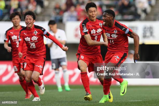 Gustavo of Roasso Kumamoto celebrates scoring the opening goal wiith his team mates during the J.League J2 match between Roasso Kumamoto and...