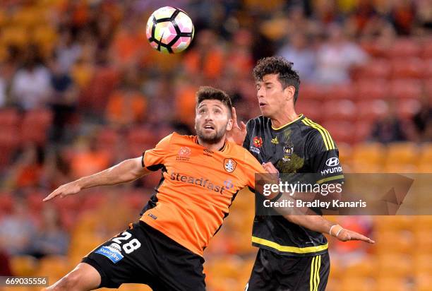 Brandon Borrello of the Roar and Guilherme Finkler of the Phoenix challenge for the ball during the round 27 A-League match between the Brisbane Roar...