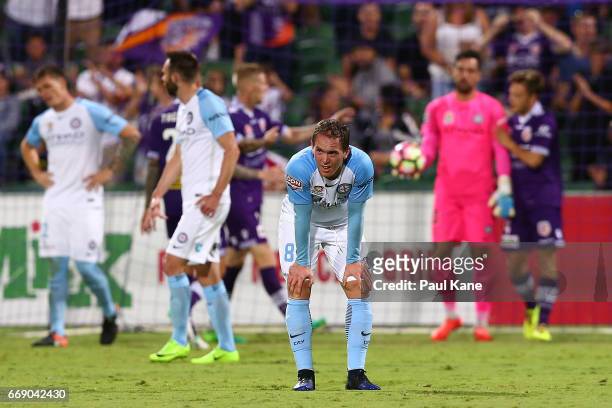 Neil Kilkenny of Melbourne looks on after a goal by Chris Harold of the Glory during the round 27 A-League match between the Perth Glory and...