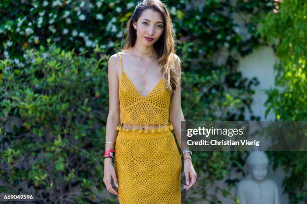 Hannah wearing a mustard dress, Gucci slippers attends day 2 of the 2017 Coachella Valley Music & Arts Festival Weekend 1 on April 15, 2017 in Indio,...