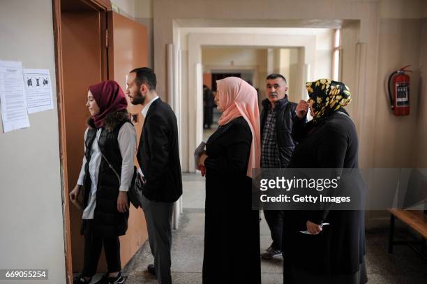 People queue at a polling station during a referendum in Istanbul, April 16, 2017 Turkey. Millions of Turks are heading to the polls to vote on a set...