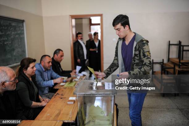 Man casts his ballot at a polling station during a referendum in Istanbul, April 16, 2017 Turkey. Millions of Turks are heading to the polls to vote...