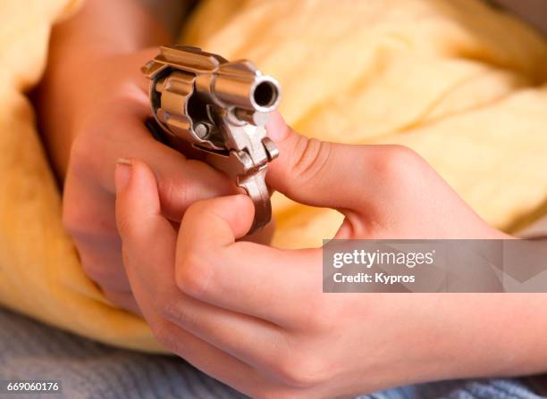 little boy age 7 years playing with a toy gun - arma de brinquedo imagens e fotografias de stock