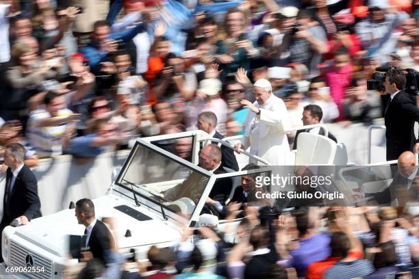 Pope Francis waves to the faithful as he leaves St. Peter's Square at the end of the Easter Mass on April 16, 2017 in Vatican City, Vatican. The...