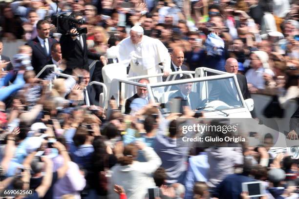 Pope Francis waves to the faithful as he leaves St. Peter's Square at the end of the Easter Mass on April 16, 2017 in Vatican City, Vatican. The...