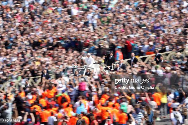 Pope Francis waves to the faithful as he leaves St. Peter's Square at the end of the Easter Mass on April 16, 2017 in Vatican City, Vatican. The...