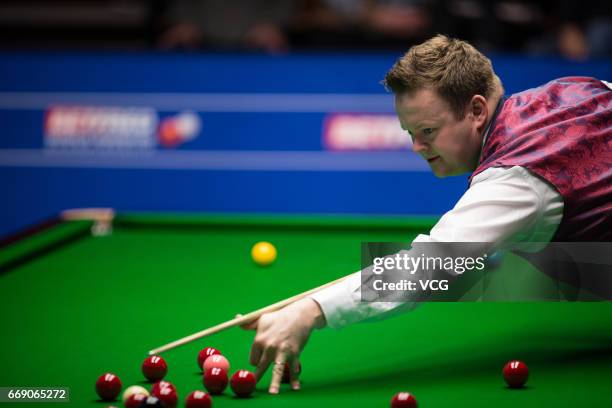 Shaun Murphy of England plays a shot during his first round match against Yan Bingtao of China on day two of Betfred World Championship 2017 at...