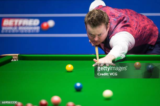 Shaun Murphy of England plays a shot during his first round match against Yan Bingtao of China on day two of Betfred World Championship 2017 at...