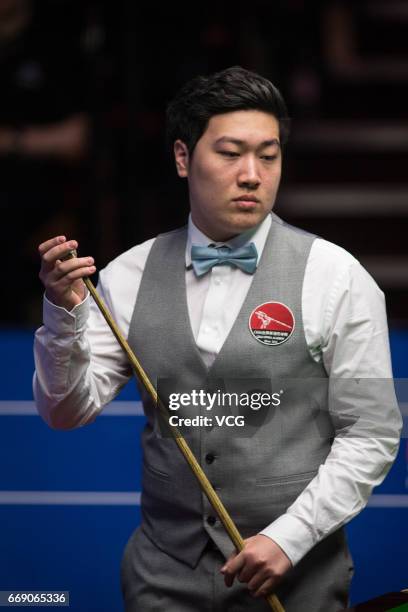 Yan Bingtao of China reacts during his first round match against Shaun Murphy of England on day two of Betfred World Championship 2017 at Crucible...