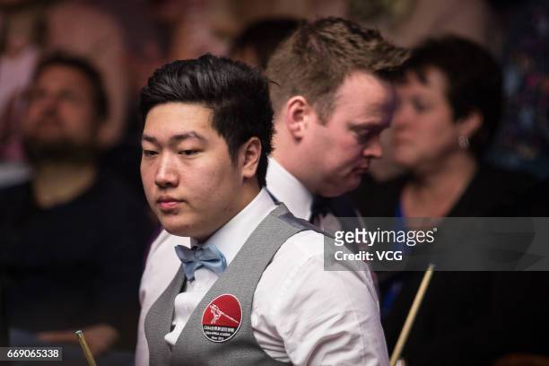 Yan Bingtao of China reacts during his first round match against Shaun Murphy of England on day two of Betfred World Championship 2017 at Crucible...