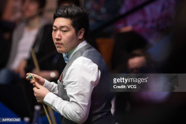 Yan Bingtao of China reacts during his first round match against Shaun Murphy of England on day two of Betfred World Championship 2017 at Crucible...