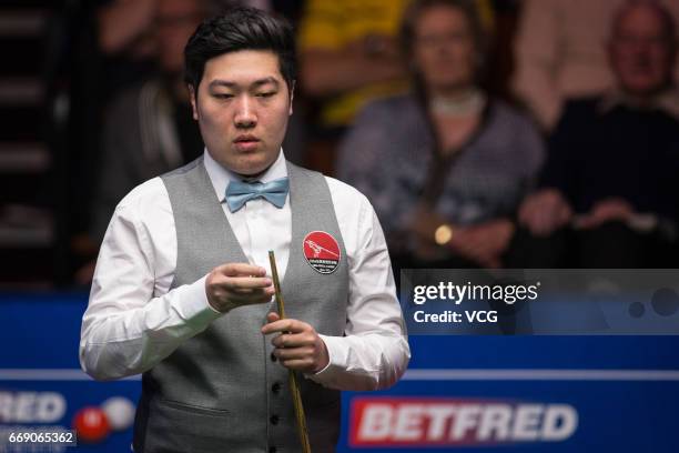 Yan Bingtao of China reacts during his first round match against Shaun Murphy of England on day two of Betfred World Championship 2017 at Crucible...