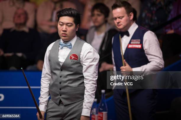 Yan Bingtao of China reacts during his first round match against Shaun Murphy of England on day two of Betfred World Championship 2017 at Crucible...