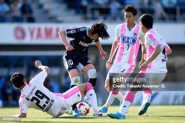 Shunsuke Nakamura of Jubilo Iwata controls the ball under pressure of Hiroyuki Taniguchi , Daichi Kamada and Riki Harakawa of Sagan Tosu during the...