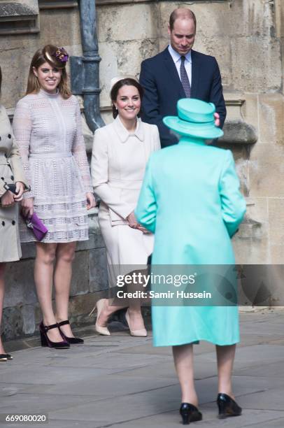 Catherine, Duchess of Cambridge performs a curtsy to Queen Elizabeth II as she attends Easter Day Service with Prince William, Duke of Cambridge and...