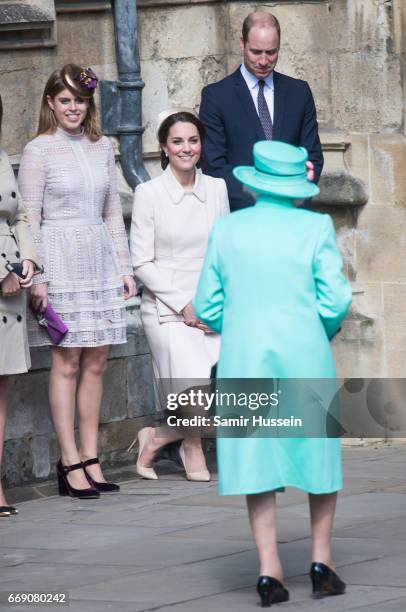 Catherine, Duchess of Cambridge performs a curtsy to Queen Elizabeth II as she attends Easter Day Service with Prince William, Duke of Cambridge and...