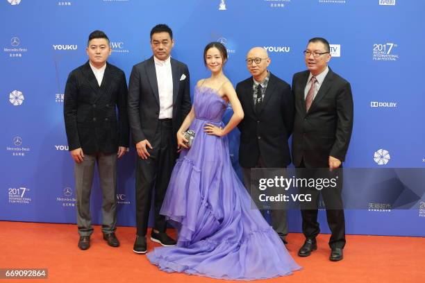 Actress Jiang Yiyan and actor Sean Lau Ching-wan arrive at the red carpet of the opening ceremony of 2017 Beijing International Film Festival on...