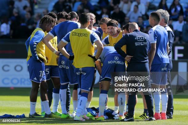 Bastia's French midfielder Yannick Cahuzac and team's captian, speaks with his teammates prior to the French L1 Football match between Bastia and...
