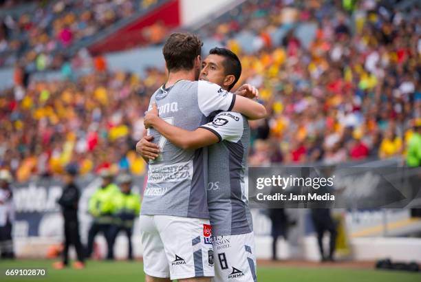 Elias Hernandez of Leon celebrates with teammate after scoring the first goal of his team during the 14th round match between Morelia and Leon as...