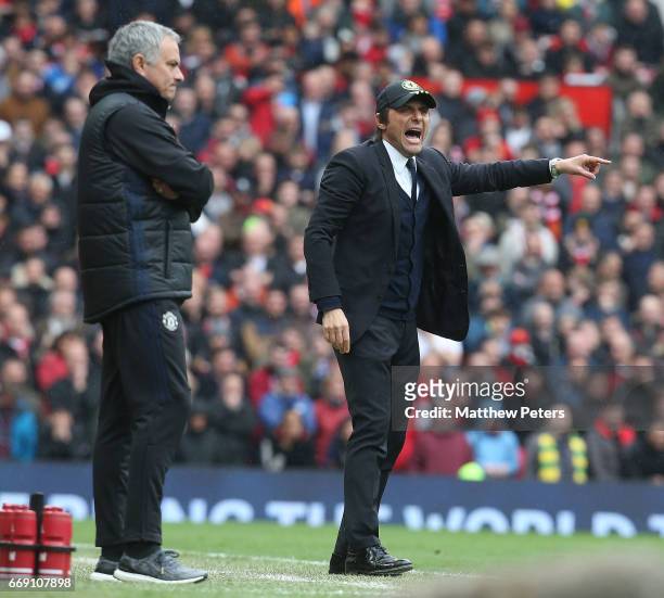 Manager Jose Mourinho of Manchester United and Manager Antonio Conte of Chelsea watch from the touchline during the Premier League match between...