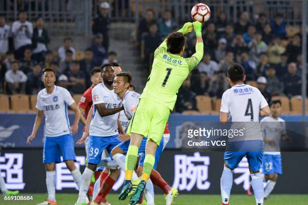 Du Jia of Tianjin TEDA tries to catch the ball during 2017 Chinese Super League 5th round match between Tianjin TEDA F.C. And Guangzhou Evergrande...