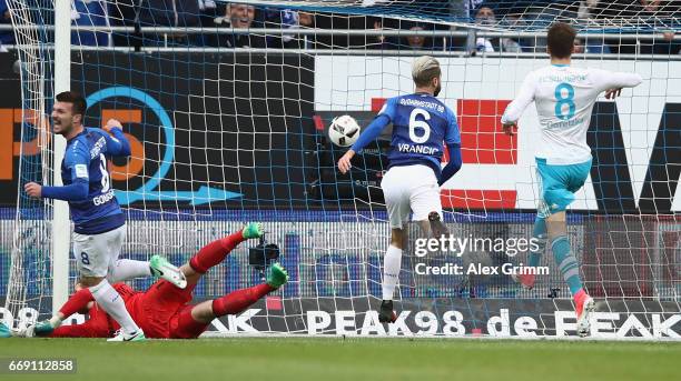 Mario Vrancic of Darmstadt scores his team's first goal past goalkeeper Ralf Faehrmann of Schalke during the Bundesliga match between SV Darmstadt 98...