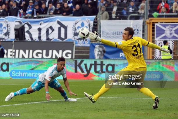 Goalkeeper Michael Esser of Darmstadt makes a save againt Dennis Aogo of Schalke during the Bundesliga match between SV Darmstadt 98 and FC Schalke...
