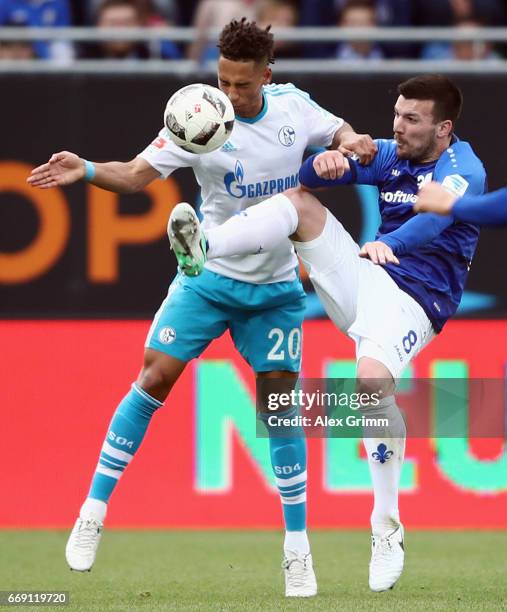 Thilo Kehrer of Schalke is challenged by Jerome Gondorf of Darmstadt during the Bundesliga match between SV Darmstadt 98 and FC Schalke 04 at Stadion...