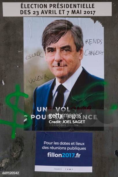 This picture taken in Paris on April 15 shows an electoral poster of French presidential election candidate for the right-wing Les Republicains party...
