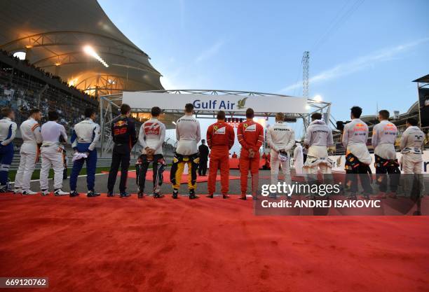 Drivers pose for a group picture ahead of the Bahrain Formula One Grand Prix at the Sakhir circuit in Manama on April 16, 2017. / AFP PHOTO / ANDREJ...