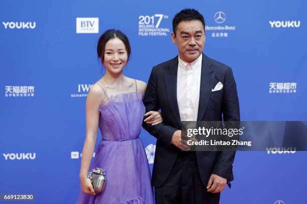 Actress Jiang Yiyan and actor Sean Lau Ching-wan arrive at the red carpet of the opening ceremony of 2017 Beijing International Film Festival on...