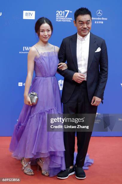 Actress Jiang Yiyan and actor Sean Lau Ching-wan arrive at the red carpet of the opening ceremony of 2017 Beijing International Film Festival on...