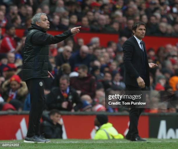 Manager Jose Mourinho of Manchester United and Manager Antonio Conte of Chelsea watch from the touchline during the Premier League match between...