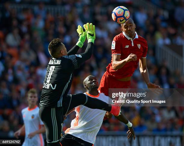 Diego Alves and Eliaquim Mangala of Valencia competes for the ball with Steven N'Zonzi of Sevilla during the La Liga match between Valencia CF and...