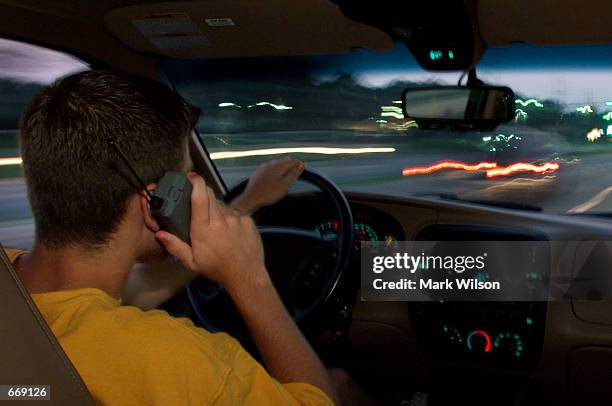 Aaron Mitchell uses his cellular phone while driving through traffic July 18, 2000 in Prince Frederick MD. Federal authorities fear the use of...