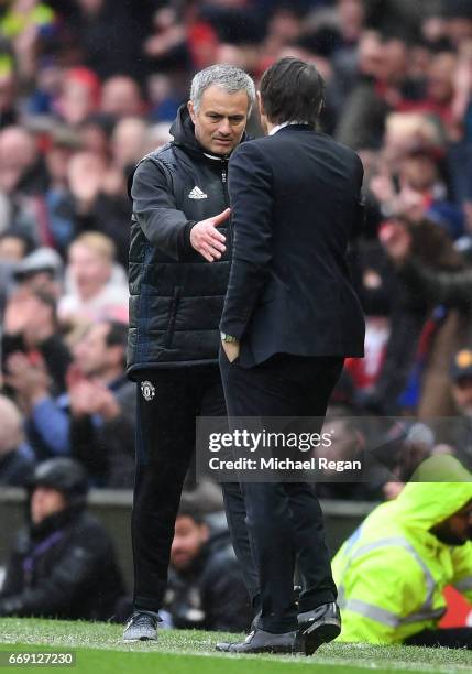 Jose Mourinho, Manager of Manchester United and Antonio Conte, Manager of Chelsea shake hands after the Premier League match between Manchester...