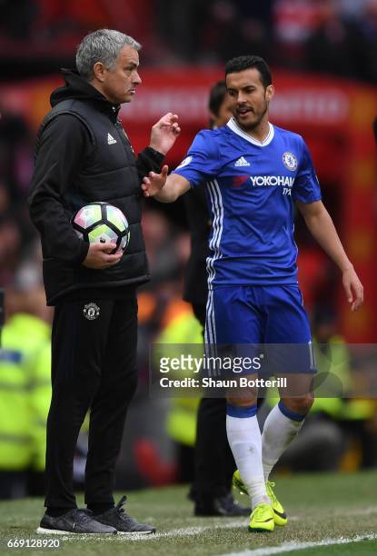 Jose Mourinho, Manager of Manchester United and Pedro of Chelsea exchange words during the Premier League match between Manchester United and Chelsea...