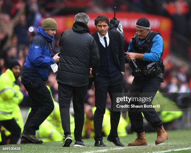 Jose Mourinho, Manager of Manchester United and Antonio Conte, Manager of Chelsea shake hands after the Premier League match between Manchester...