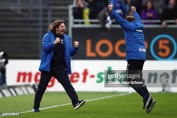 Head coach Torsten Frings and assistant coach Bjoern Mueller of Darmstadt celebrate the last minute winning goal during the Bundesliga match between...