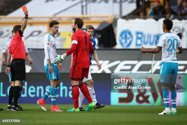 Referee Patrick Ittrich shows the red card to Thilo Kehrer of Schalke during the Bundesliga match between SV Darmstadt 98 and FC Schalke 04 at...