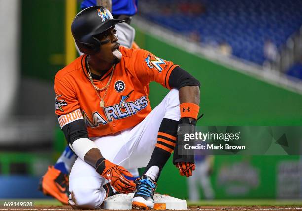 Dee Gordon of the Miami Marlins safe at third base on a throwing error in the first inning during the game between the Miami Marlins and the New York...