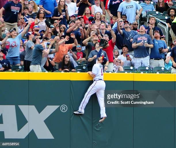 Ender Inciarte of the Atlanta Braves is unable to reach a second inning home run by Ryan Schimpf of the San Diego Padres at SunTrust Park on April...