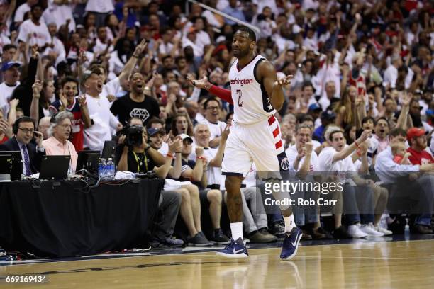 John Wall of the Washington Wizards celebrates after hitting a three pointer in the second half of the Wizards 114-107 win over the Atlanta Hawks in...
