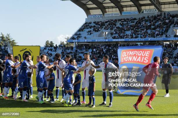 Lyon's players shake hands with Bastia's players before the L1 football match Bastia against Lyon on April 16, 2017 in the Armand Cesari stadium in...
